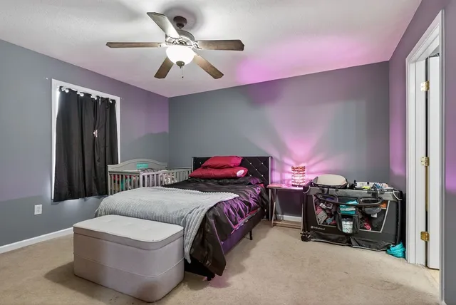 a bedroom with bed and a chandelier