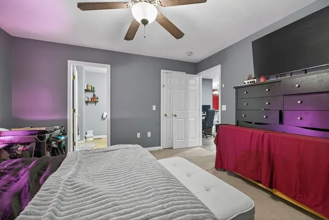 a bedroom with a bed and flat screen tv