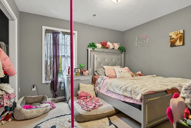 a bedroom with a bed and a dresser