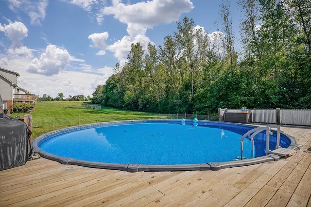a view of a swimming pool with a yard