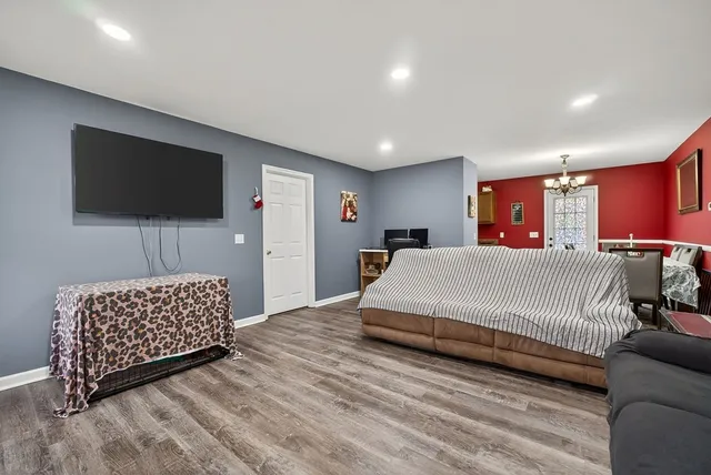 a spacious bedroom with a bed and a flat screen television