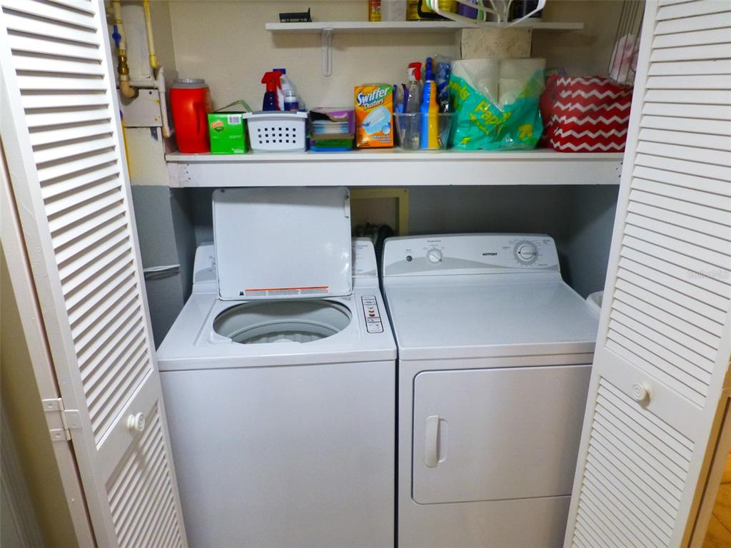 5557 Sea Forest Drive, Unit 215 New Port Richey, FL 34652 - Photo 13 of 40 a utility room with dryer and washer