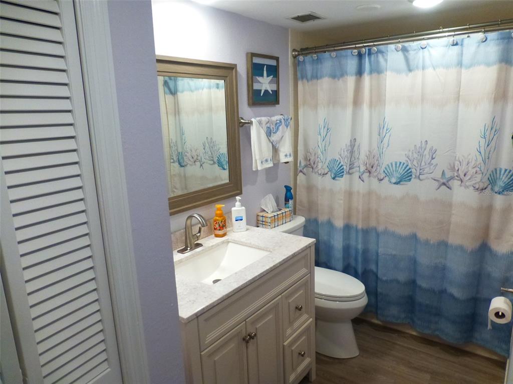 5557 Sea Forest Drive, Unit 215 New Port Richey, FL 34652 - Photo 18 of 40 a bathroom with a sink a toilet and shower
