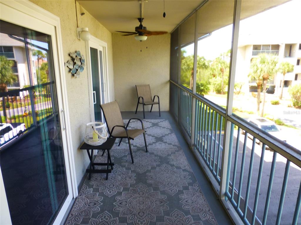 5557 Sea Forest Drive, Unit 215 New Port Richey, FL 34652 - Photo 22 of 40 a view of a porch with furniture and a window