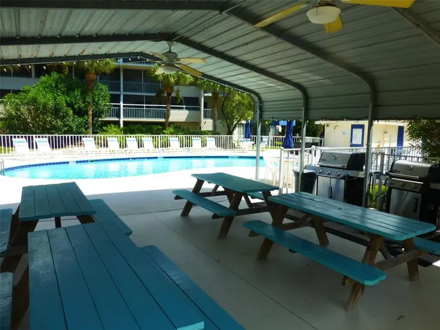 a view of a patio with couches chairs and a fire pit
