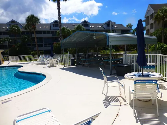 a view of swimming pool with outdoor seating and yard