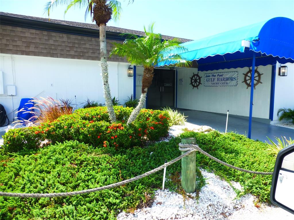 5557 Sea Forest Drive, Unit 215 New Port Richey, FL 34652 - Photo 35 of 40 a plant that is in front of a house