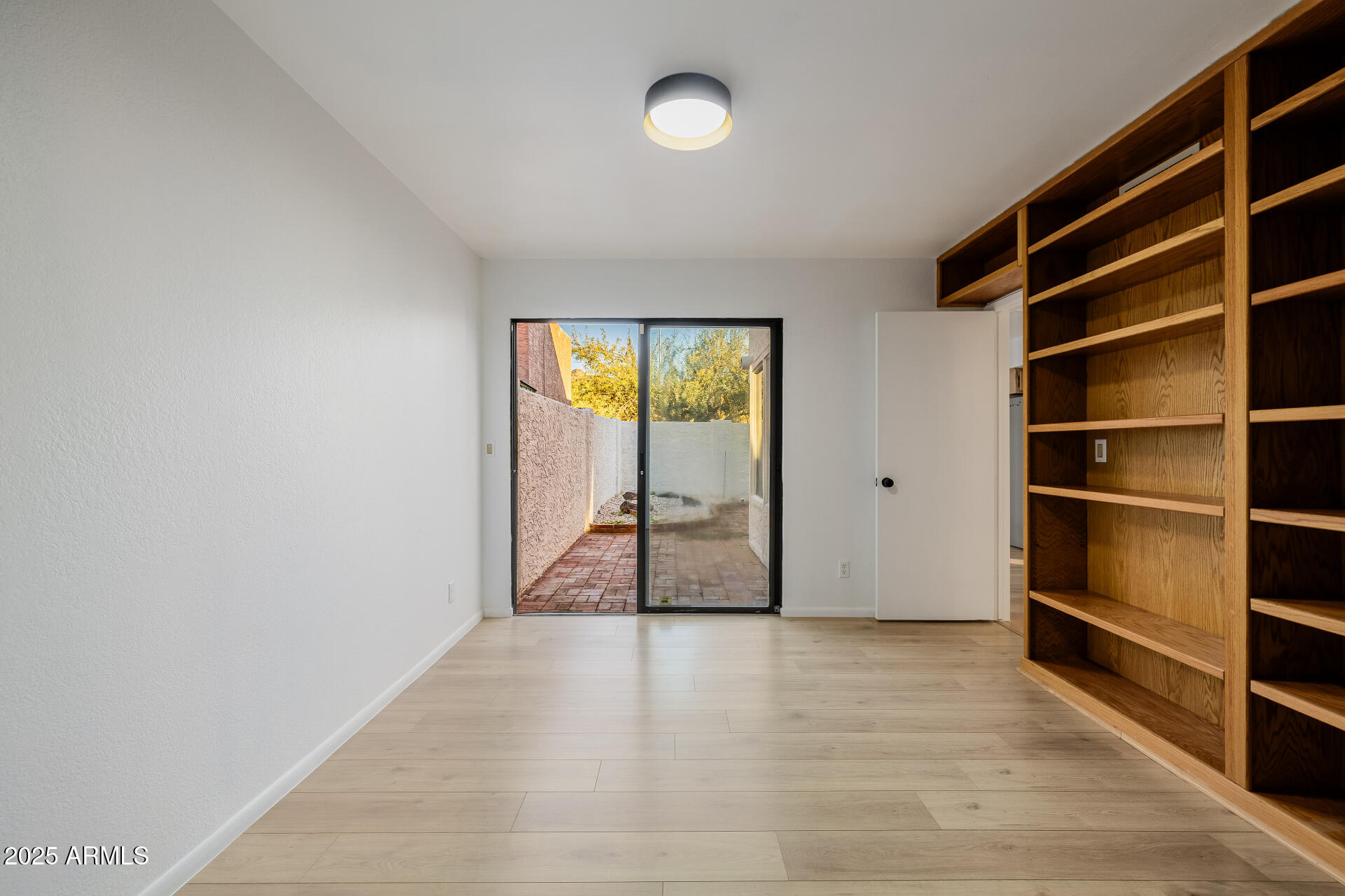 1875 East State Avenue Phoenix, AZ 85020 - Photo 28 of 39 a view of empty room with wooden floor and fan