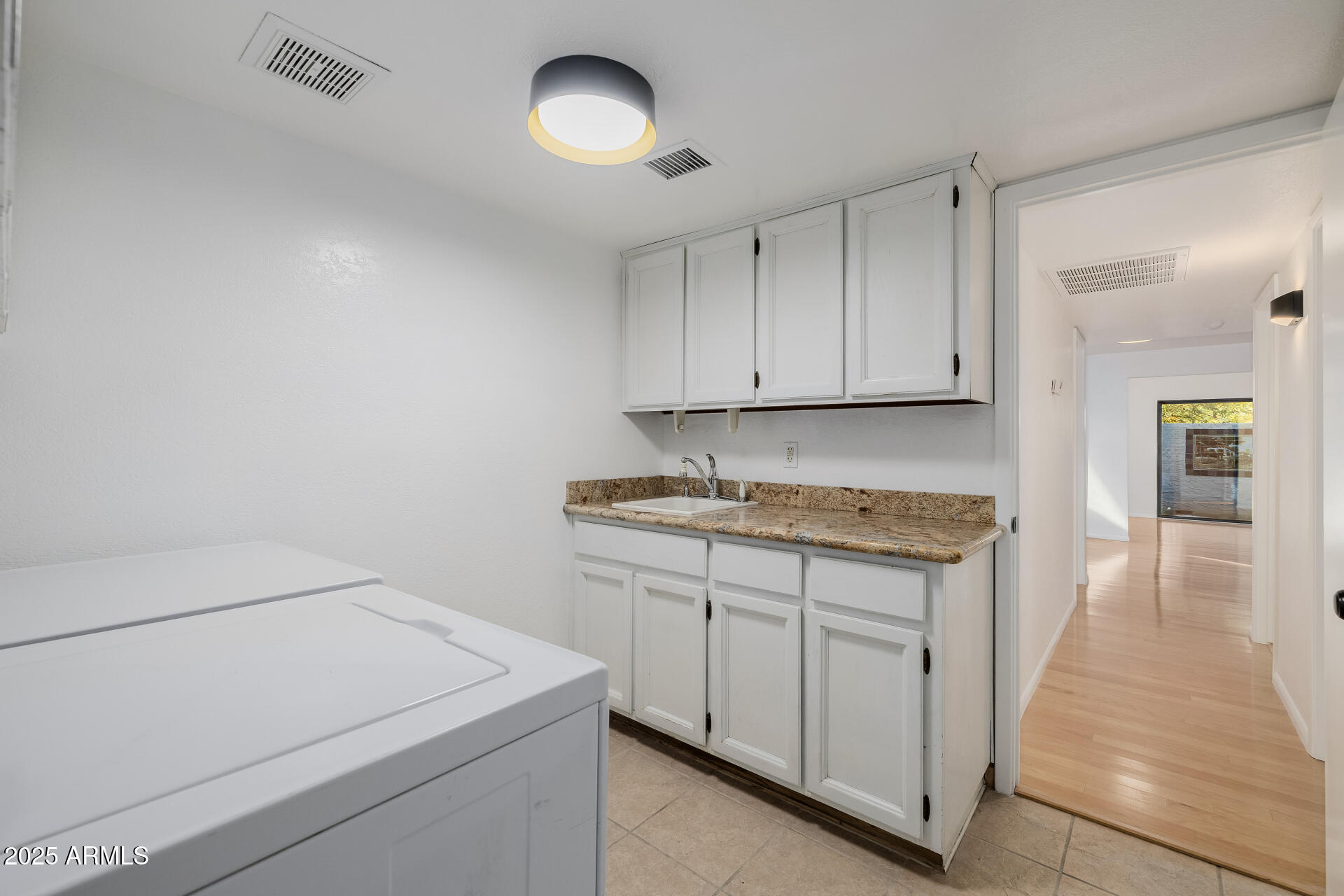 1875 East State Avenue Phoenix, AZ 85020 - Photo 30 of 39 a utility room with granite countertop cabinets washer and dryer