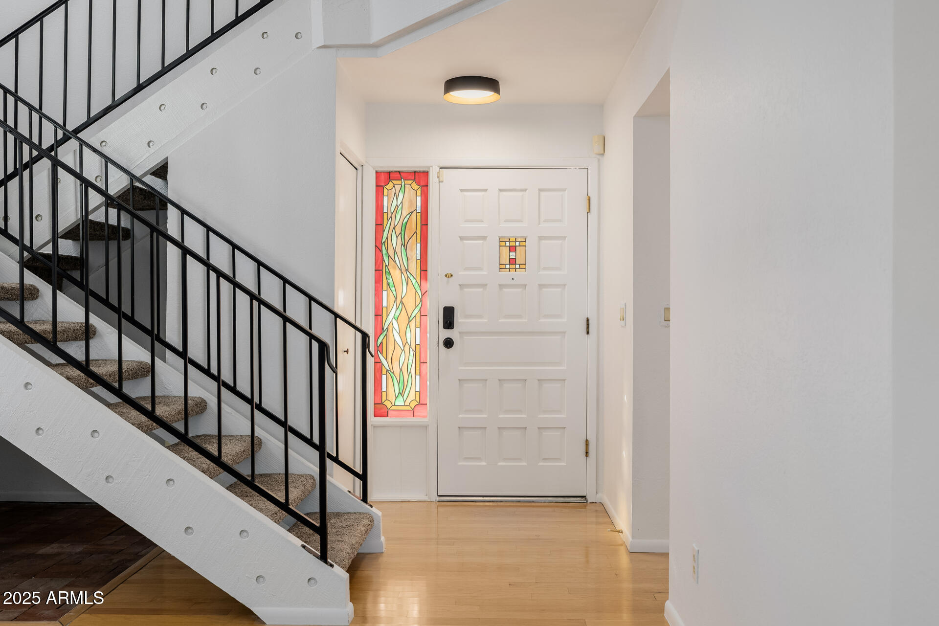 1875 East State Avenue Phoenix, AZ 85020 - Photo 4 of 39 a view of staircase with wooden floor and white walls