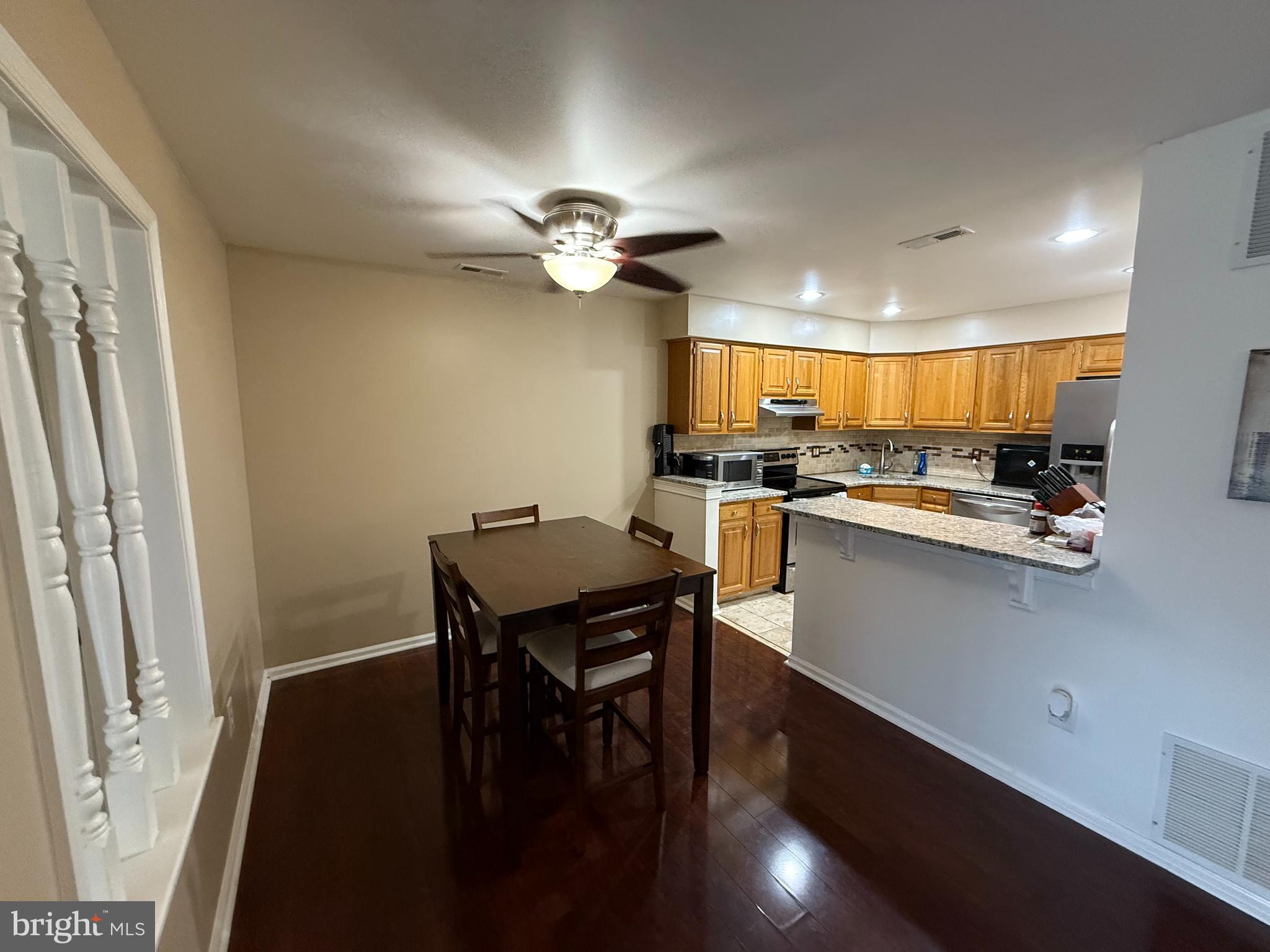 27 Pickwick Place Sewell, NJ 08080 - Photo 7 of 18 a kitchen with stainless steel appliances a table chairs and a refrigerator