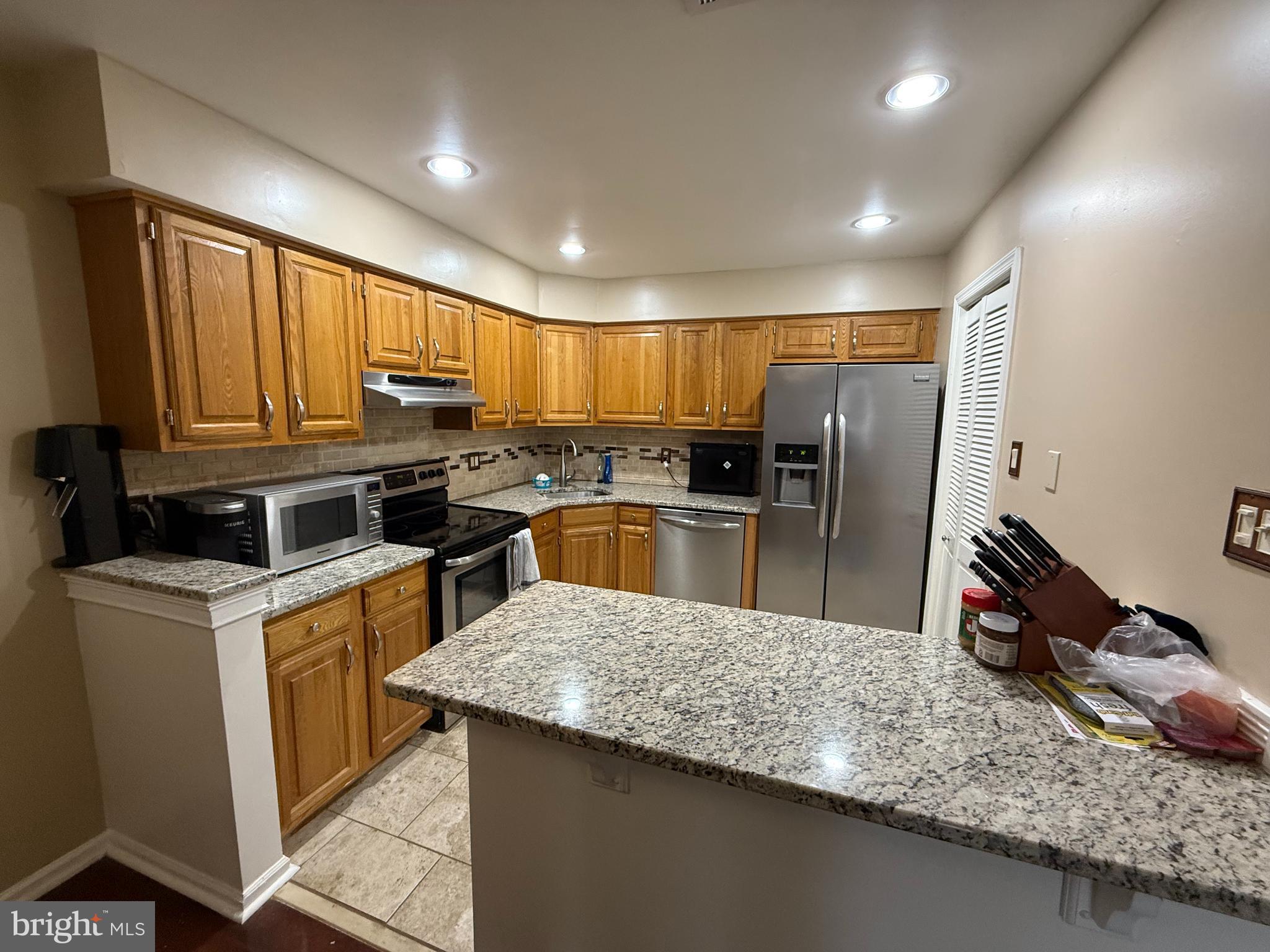 27 Pickwick Place Sewell, NJ 08080 - Photo 8 of 18 a kitchen with a sink dishwasher stove top oven and refrigerator