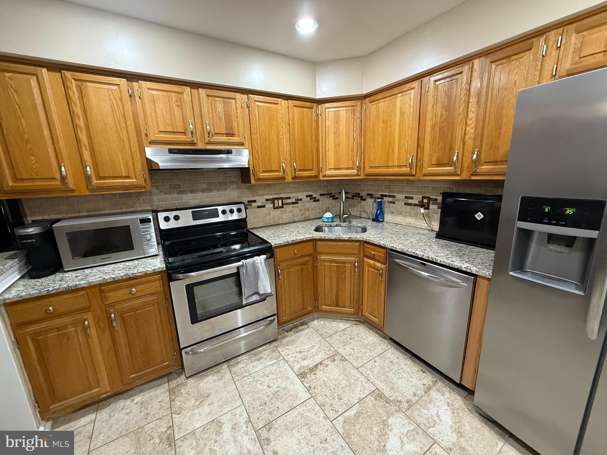27 Pickwick Place Sewell, NJ 08080 - Photo 9 of 18 a kitchen with a stove a sink and a microwave