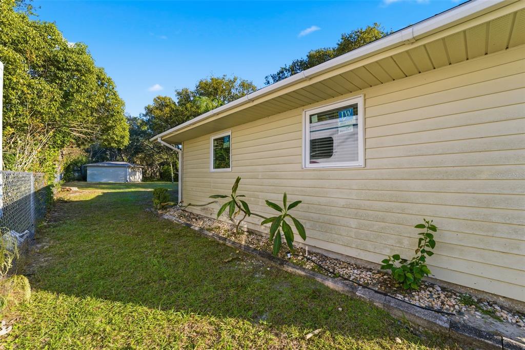 3290 Seaview Drive Spring Hill, FL 34606 - Photo 28 of 31 a backyard of a house with table and chairs