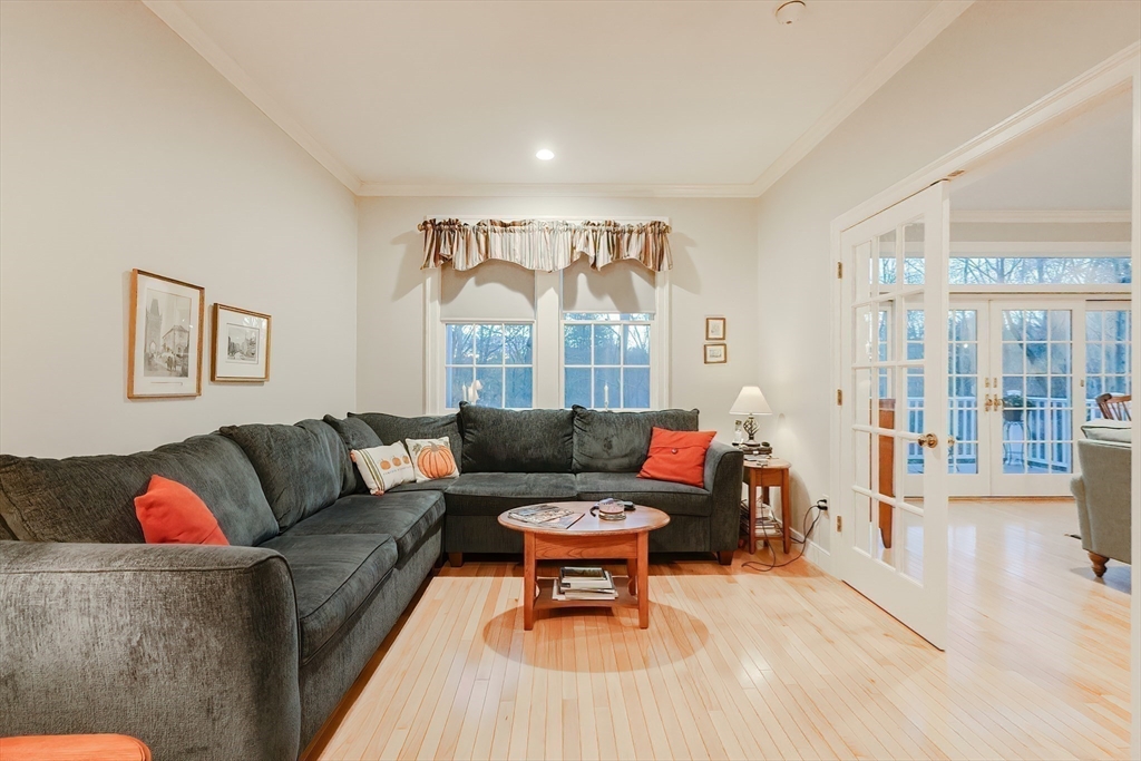 12 Highcroft Way, Unit 12 Hopkinton, MA 01748 - Photo 16 of 37 a living room with furniture and a large window