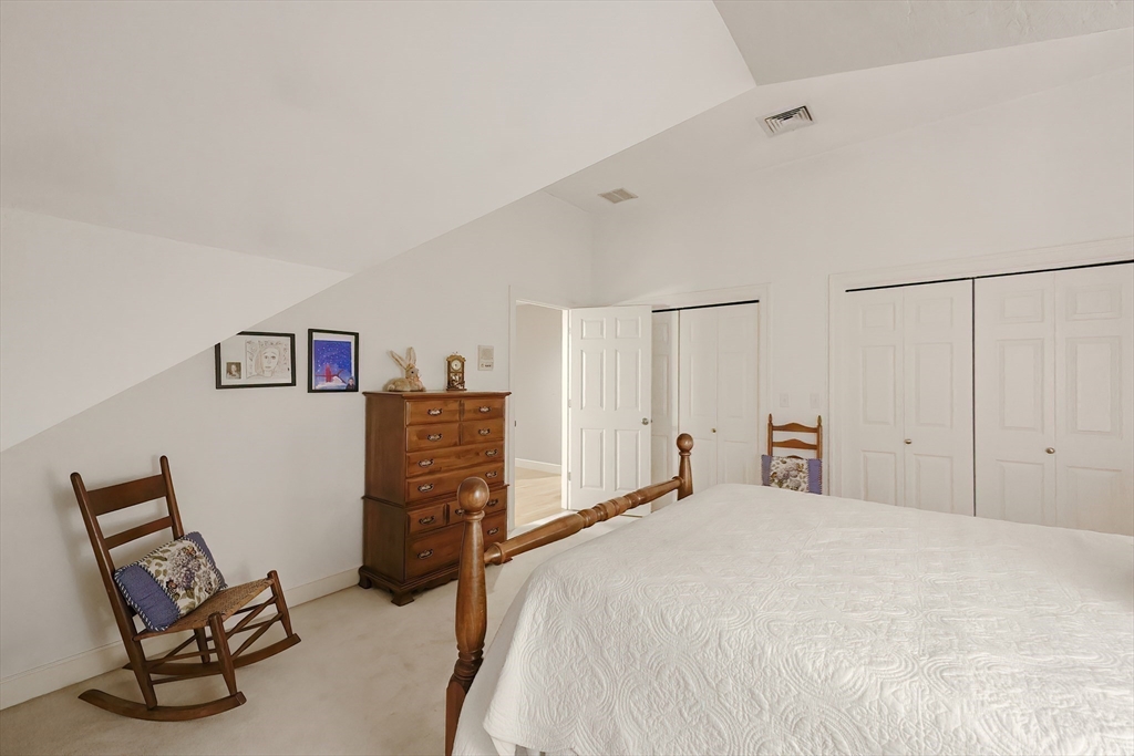 12 Highcroft Way, Unit 12 Hopkinton, MA 01748 - Photo 20 of 37 a bedroom with a bed and chair