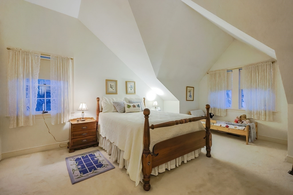 12 Highcroft Way, Unit 12 Hopkinton, MA 01748 - Photo 21 of 37 a bedroom with furniture and a window