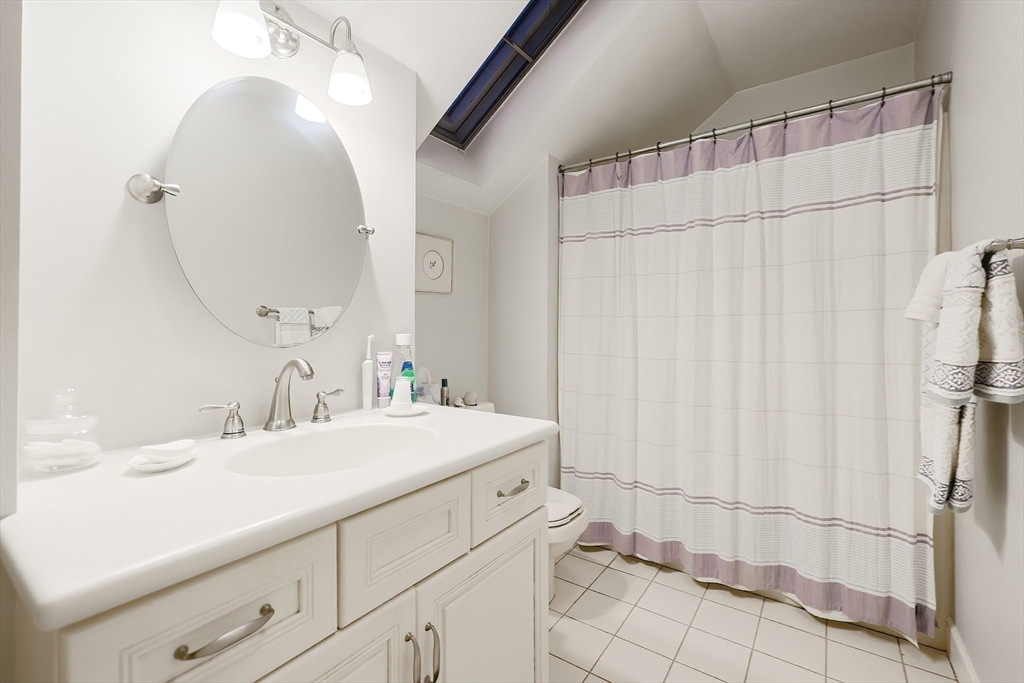 12 Highcroft Way, Unit 12 Hopkinton, MA 01748 - Photo 22 of 37 a bathroom with a sink and a mirror