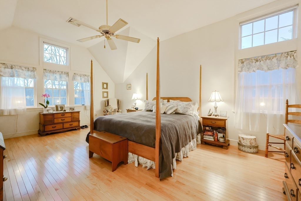 12 Highcroft Way, Unit 12 Hopkinton, MA 01748 - Photo 24 of 37 a bedroom with a bed mirror and a window