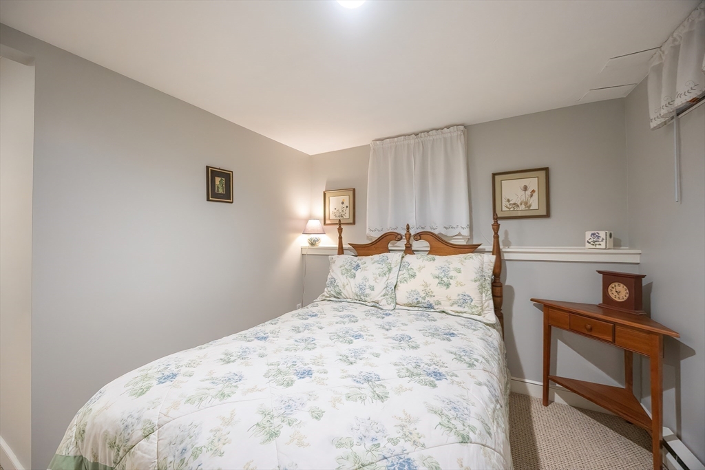 12 Highcroft Way, Unit 12 Hopkinton, MA 01748 - Photo 28 of 37 a bedroom with a bed and a window