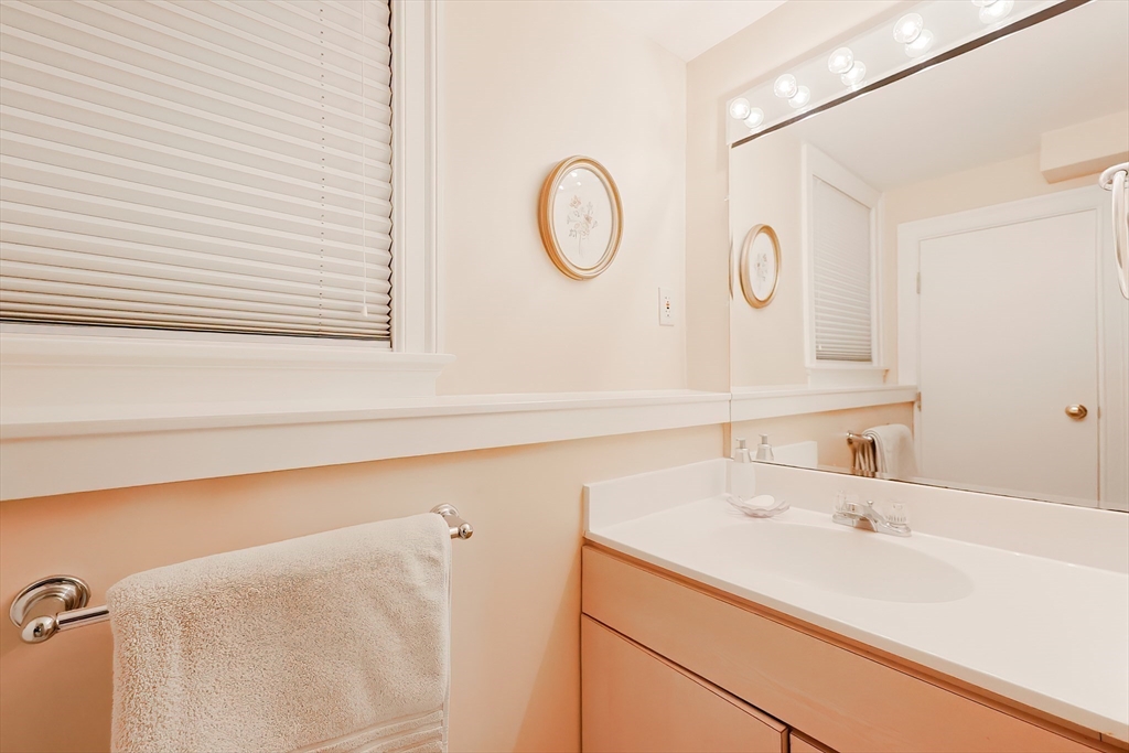 12 Highcroft Way, Unit 12 Hopkinton, MA 01748 - Photo 29 of 37 a bathroom with a sink and a mirror