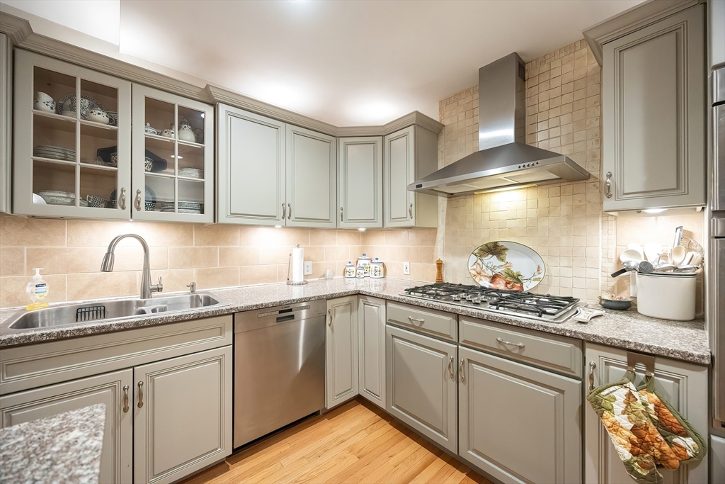 12 Highcroft Way, Unit 12 Hopkinton, MA 01748 - Photo 3 of 37 a kitchen with stainless steel appliances granite countertop a sink stove and cabinets