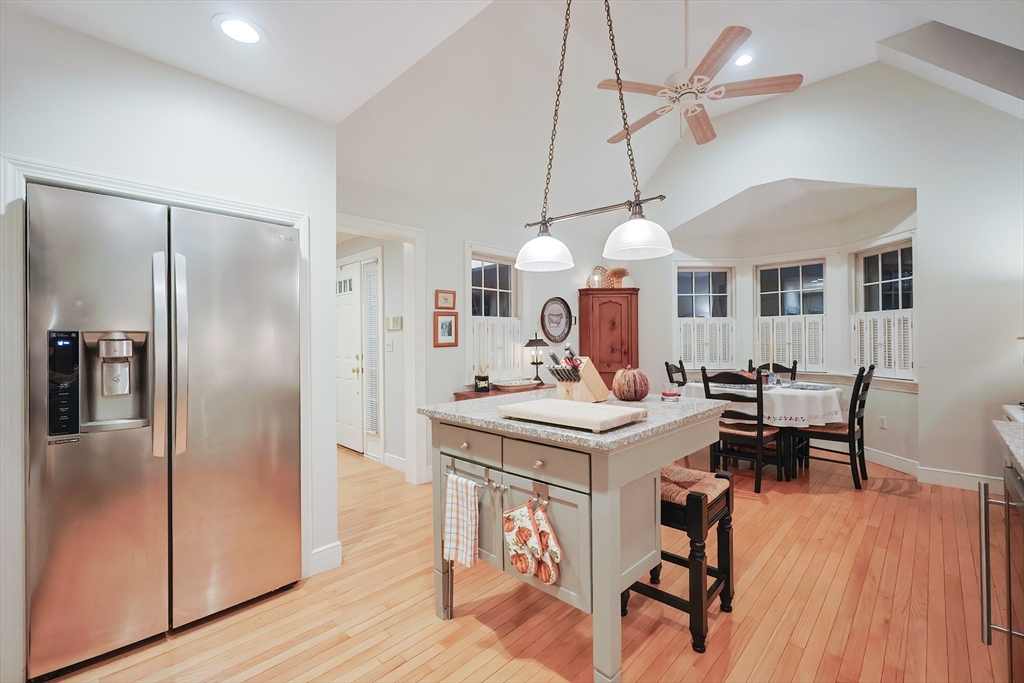 12 Highcroft Way, Unit 12 Hopkinton, MA 01748 - Photo 5 of 37 a view of a dining room with furniture a chandelier and wooden floor