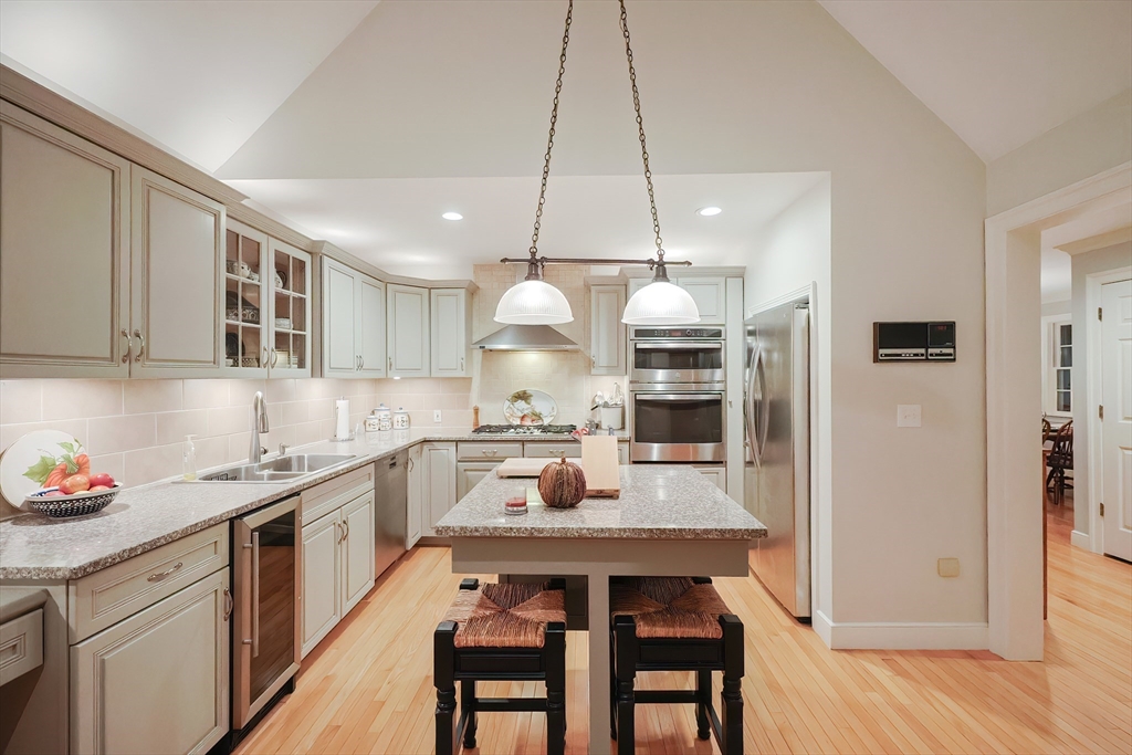 12 Highcroft Way, Unit 12 Hopkinton, MA 01748 - Photo 6 of 37 a kitchen with a dining table chairs sink and stove