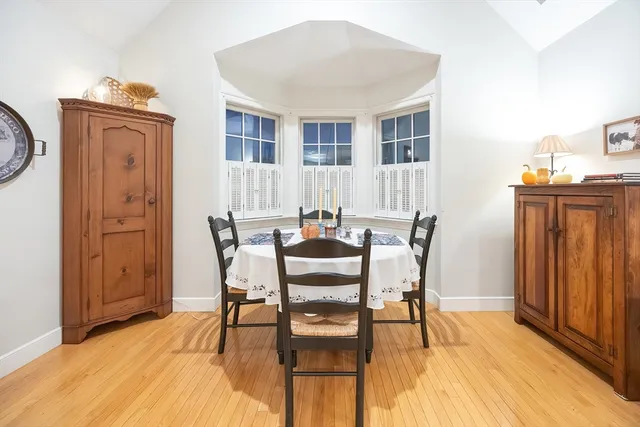 a dining room with furniture and wooden floor