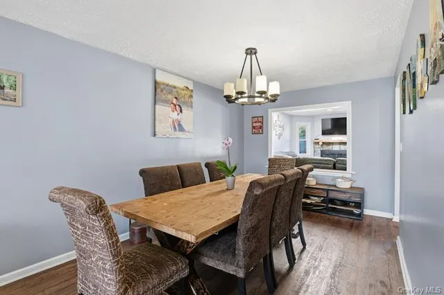 a view of a dining room with furniture wooden floor and chandelier