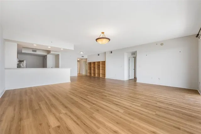 a view of a room with wooden floor and window