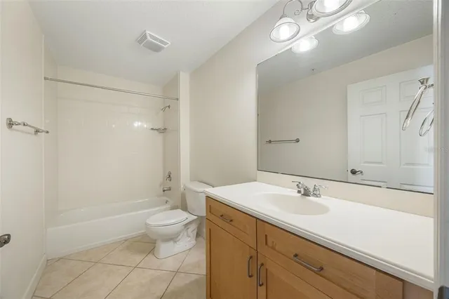 a spacious bathroom with a sink a toilet a shower and a mirror