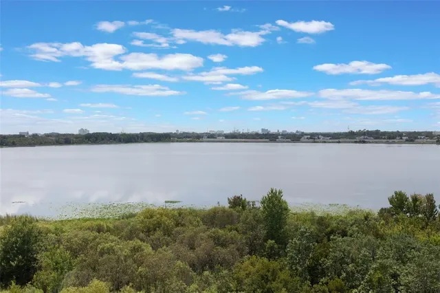 a view of a lake with houses in the back