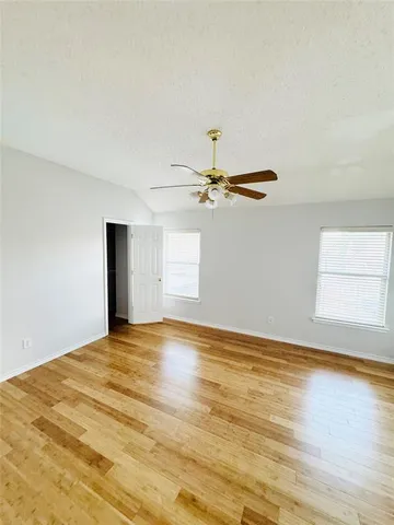 a view of empty room with wooden floor