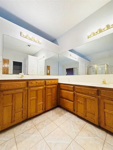 a large white kitchen with a sink and dishwasher