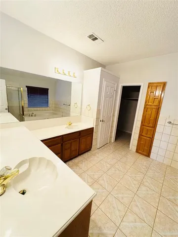 a view of kitchen with stainless steel appliances a sink and a refrigerator
