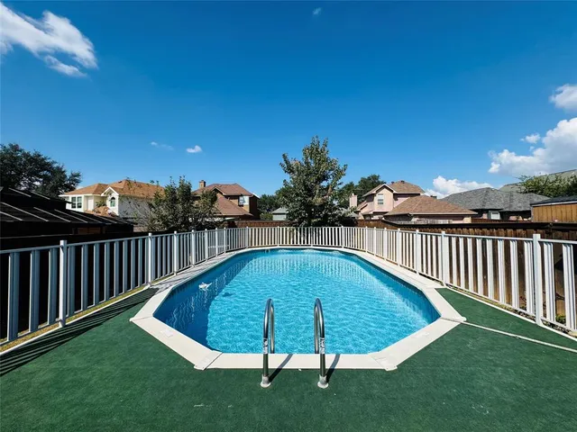 a view of a backyard with swimming pool