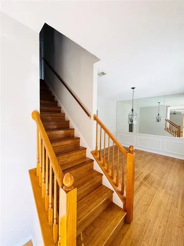 a view of entryway and hall with wooden floor