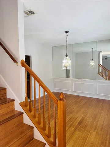 a view of a room with wooden floor and white walls