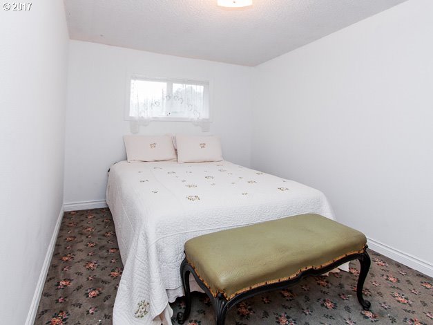 19495 Southeast Chambers Road Sandy, OR 97055 - Photo 11 of 32 a bed sitting in a bedroom next to a window