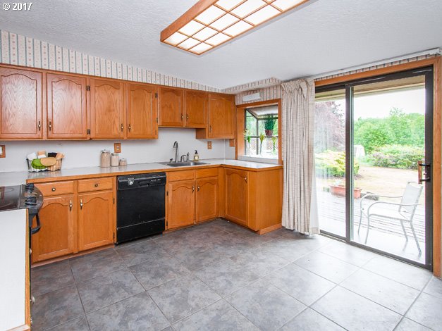 19495 Southeast Chambers Road Sandy, OR 97055 - Photo 6 of 32 a kitchen with stainless steel appliances granite countertop a stove sink and cabinets