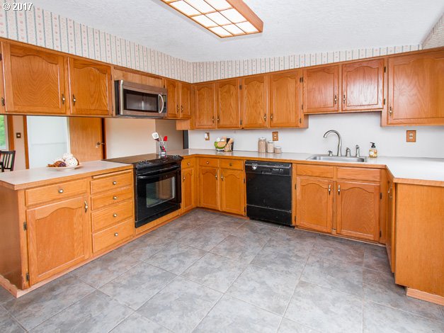 19495 Southeast Chambers Road Sandy, OR 97055 - Photo 7 of 32 a kitchen with stainless steel appliances granite countertop a sink dishwasher stove top oven and cabinets