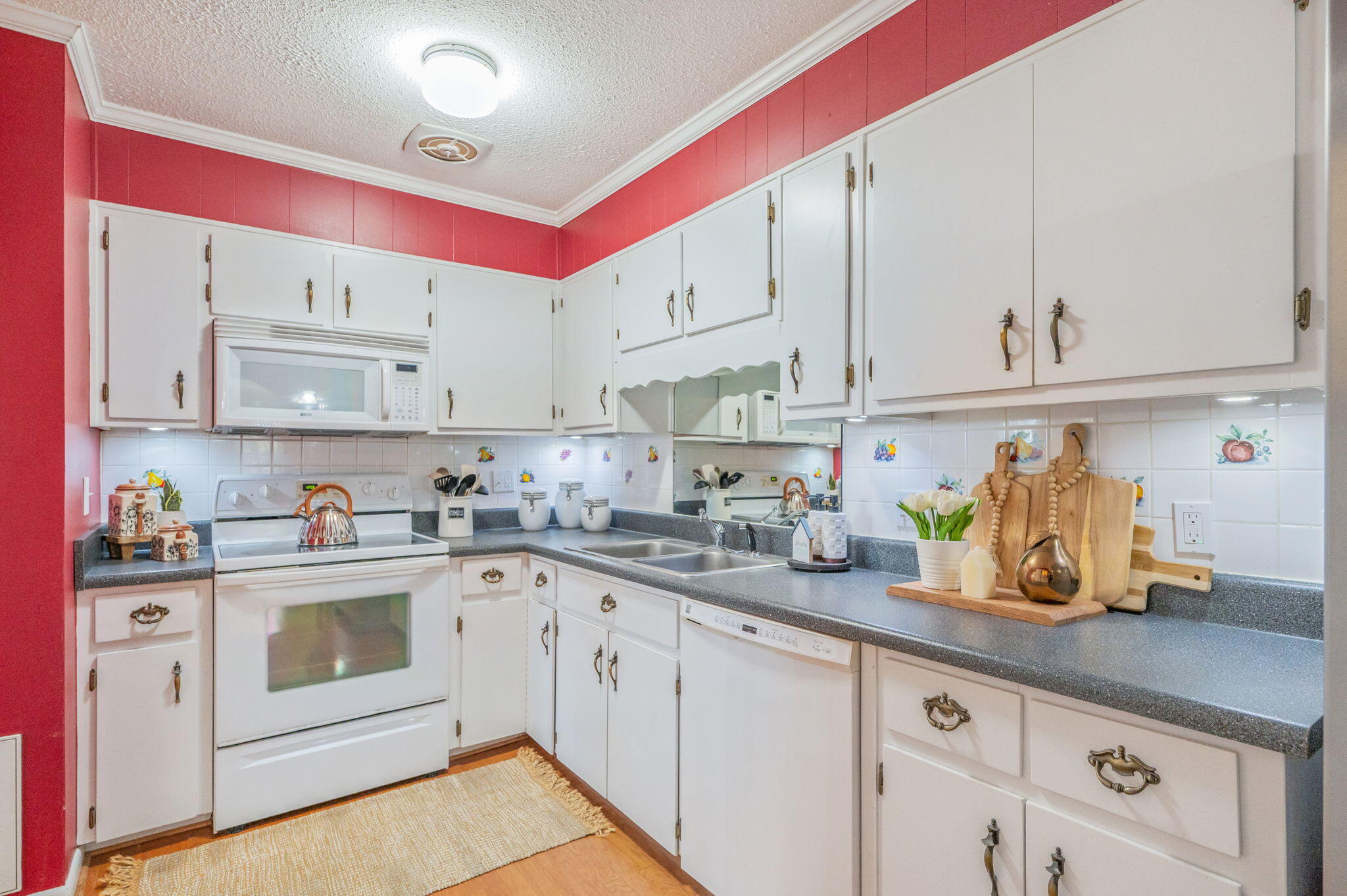 501 Jones Road Crestview, FL 32536 - Photo 14 of 32 a kitchen with white cabinets and white appliances