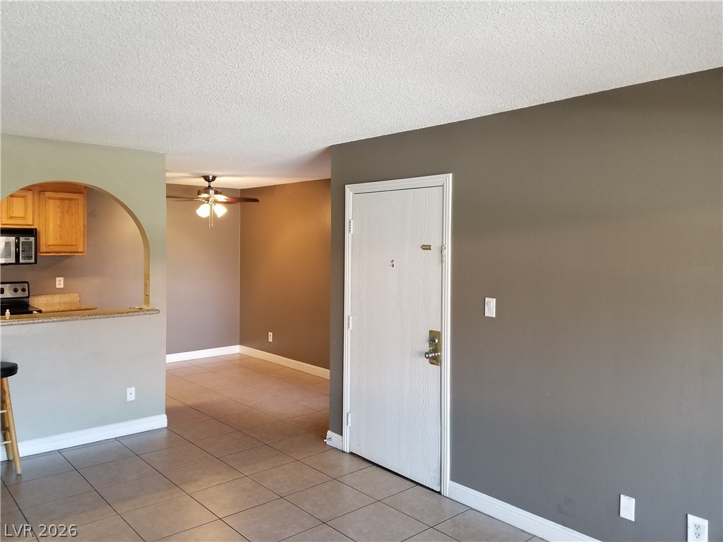 1515 East Reno Avenue, Unit A103 Las Vegas, NV 89119 - Photo 7 of 16 This living area showcases a practical open-concept layout, offering versatility for dining and entertaining.