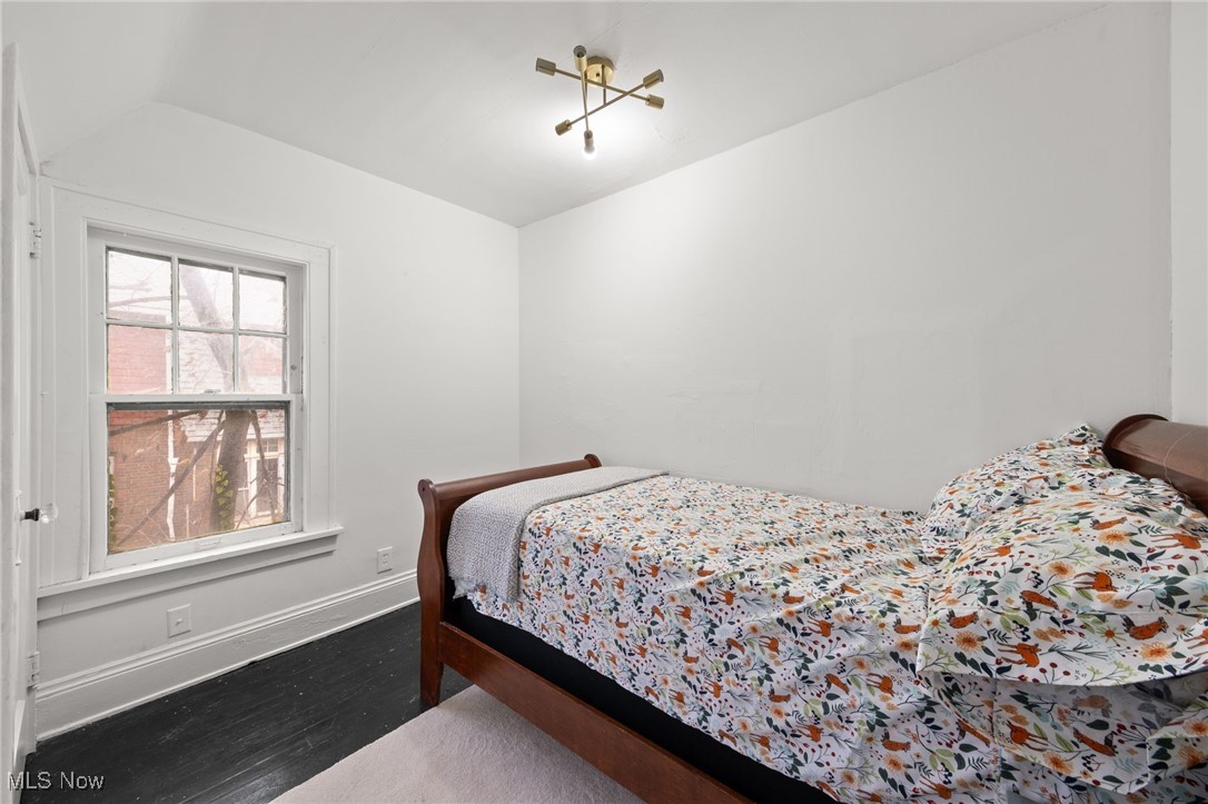 1857 Willowhurst Road Cleveland, OH 44112 - Photo 16 of 26 Bedroom with a chandelier and wood-type flooring