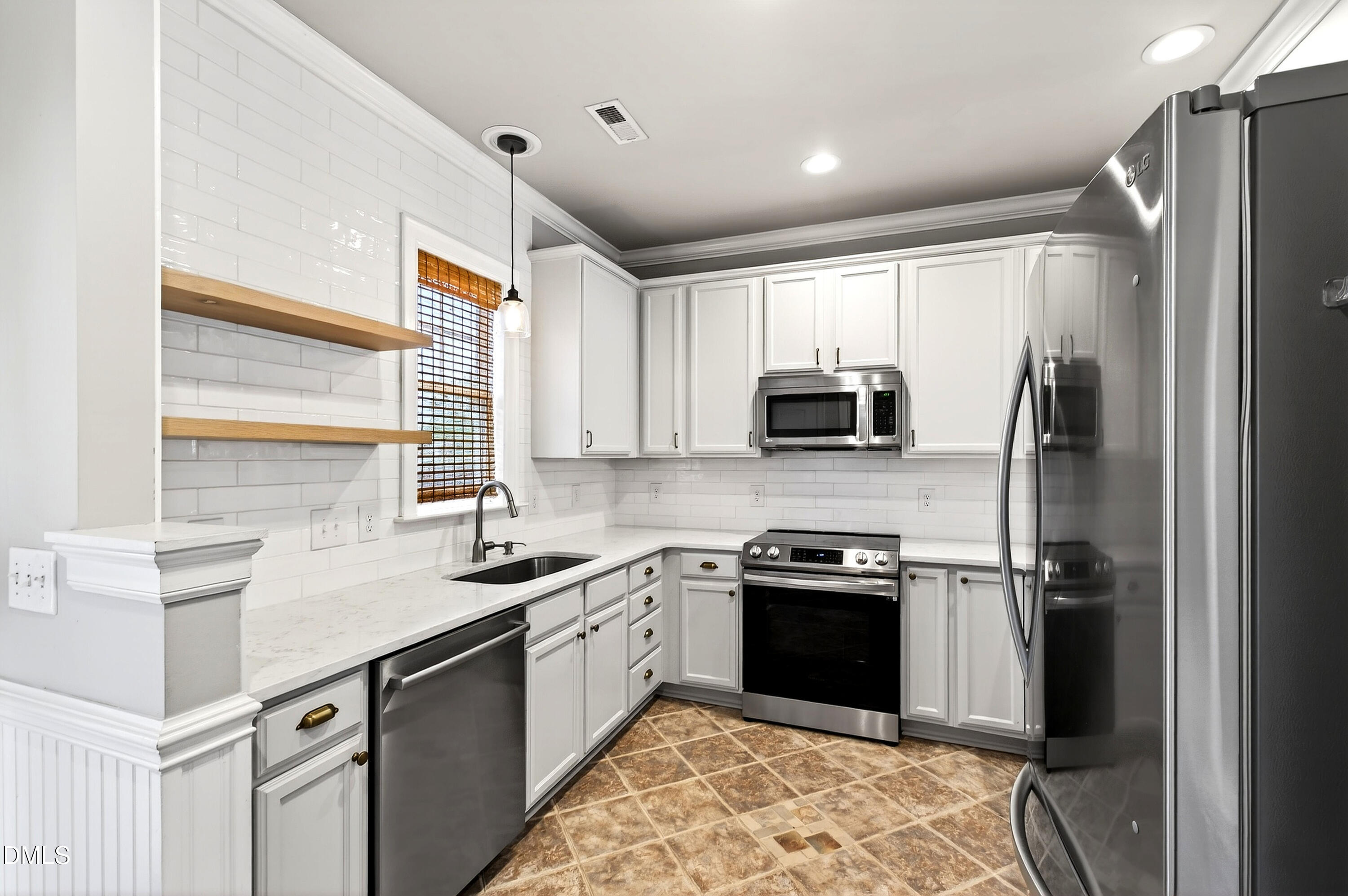 7756 ACC Boulevard Raleigh, NC 27617 - Photo 14 of 40 a kitchen with a sink stove and refrigerator