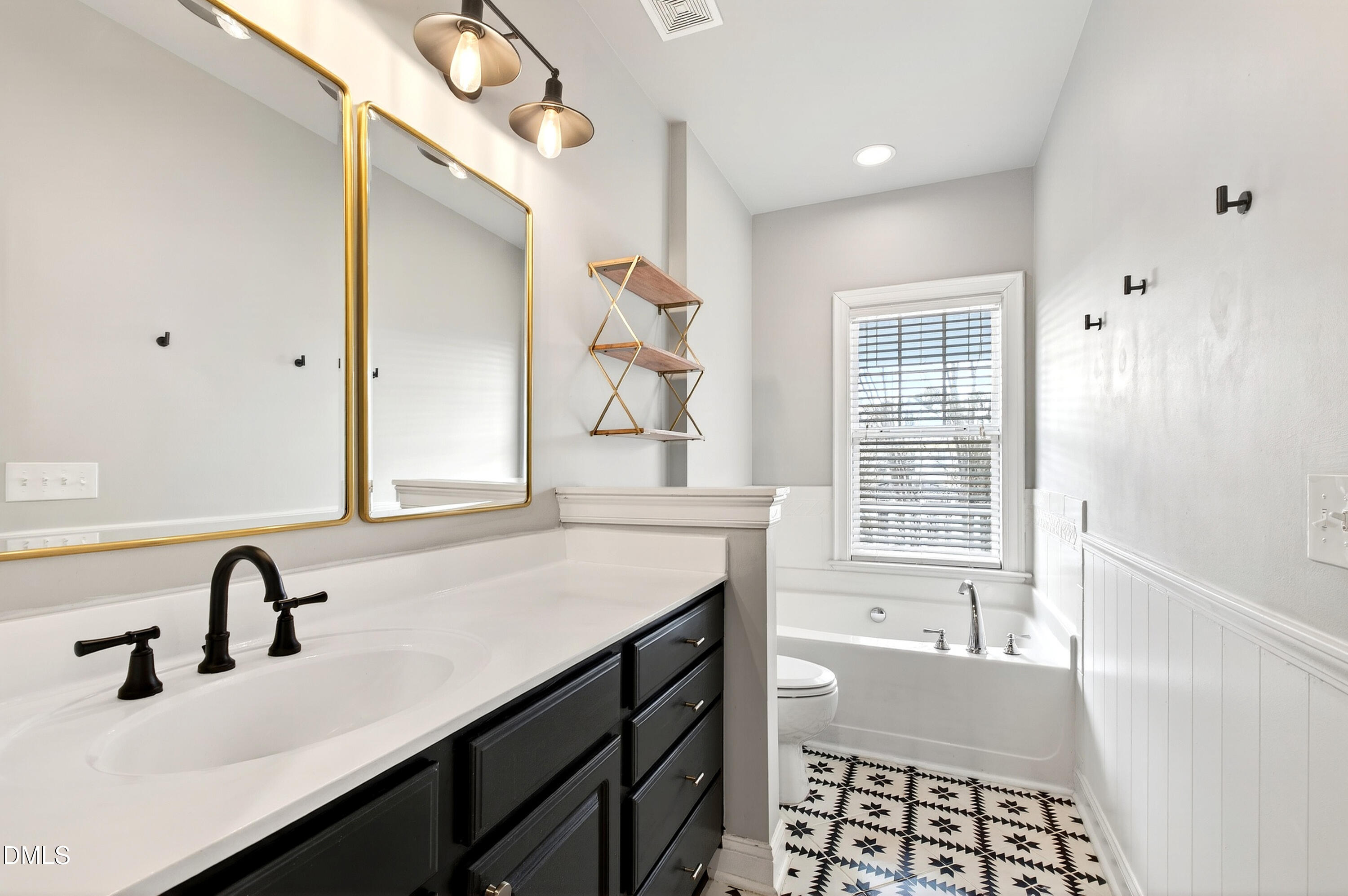 7756 ACC Boulevard Raleigh, NC 27617 - Photo 25 of 40 a bathroom with a sink double vanity and a bathtub