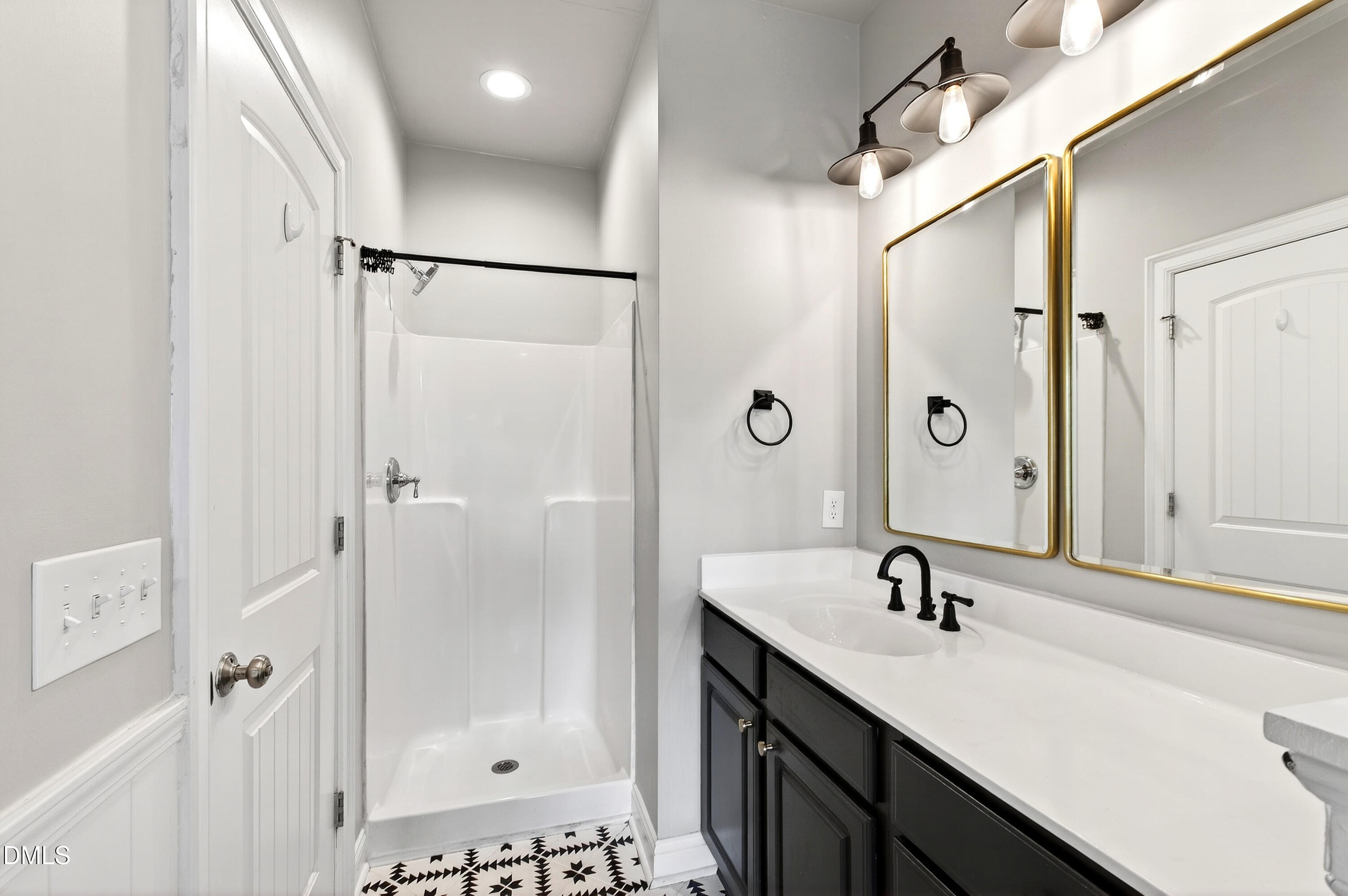 7756 ACC Boulevard Raleigh, NC 27617 - Photo 26 of 40 a bathroom with a shower sink and mirror