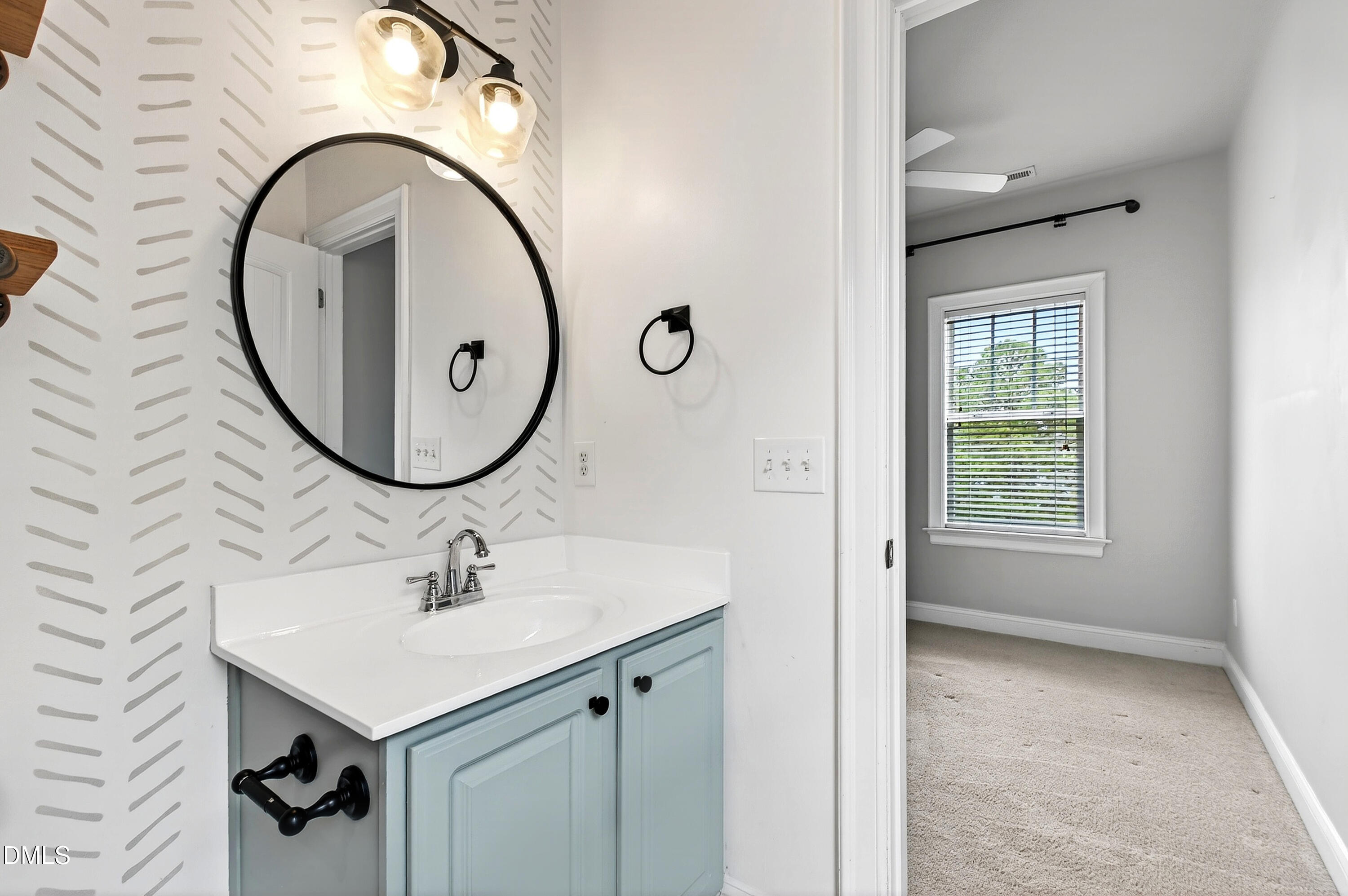 7756 ACC Boulevard Raleigh, NC 27617 - Photo 32 of 40 a bathroom with a sink a mirror and a window