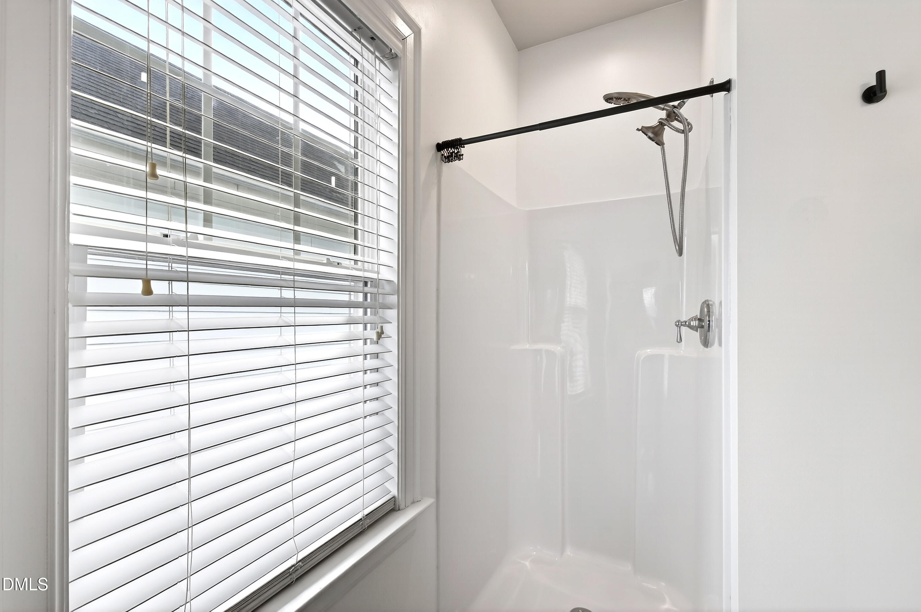 7756 ACC Boulevard Raleigh, NC 27617 - Photo 33 of 40 a bathroom with a shower and a window